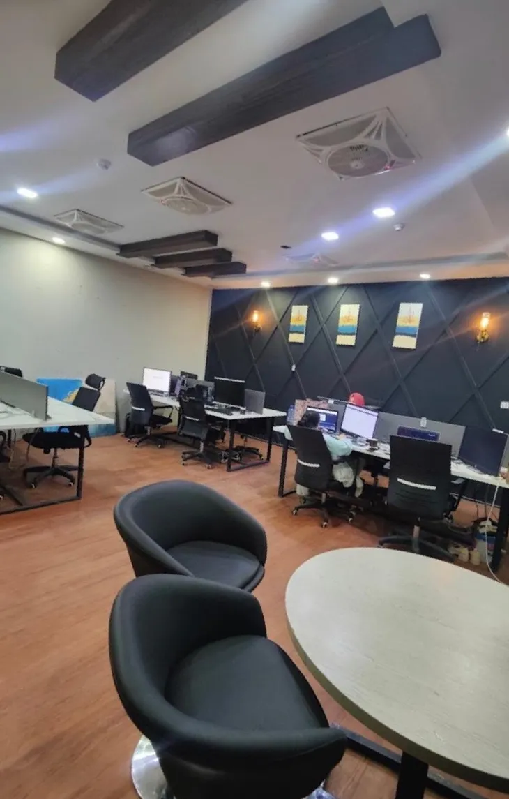 Open-plan workspace with desks and a meeting table